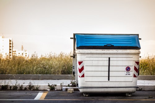 Putney Skip Hire van and skip beside a property showing safety signage
