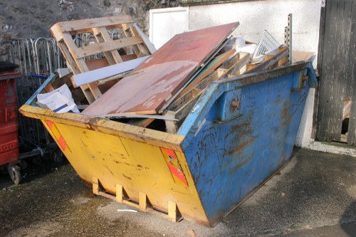 Workers sorting concrete and masonry debris at a demolition site