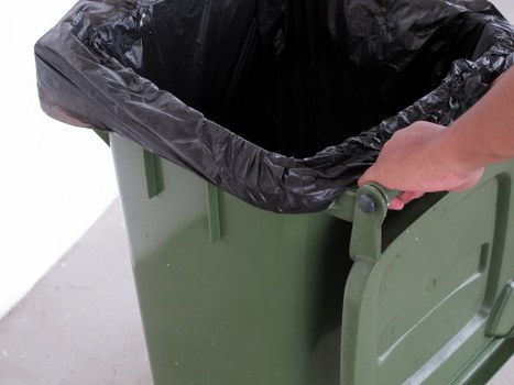 Household items being loaded into a skip in Putney